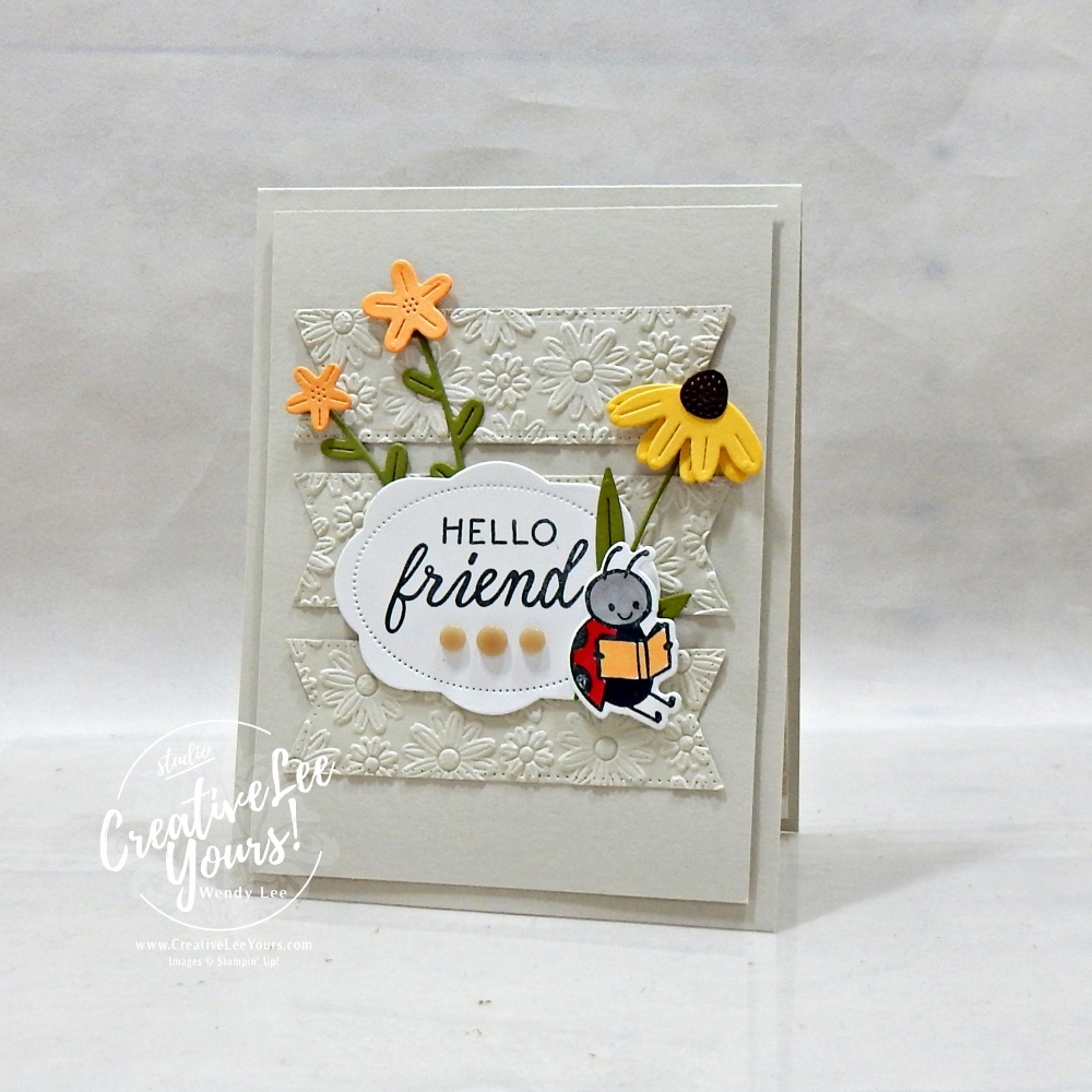 Embossed layered handmade card with die cuts and floral details using neutral cardstock and textured background