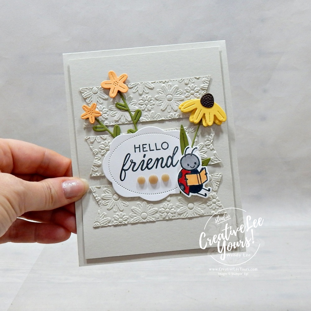 Embossed layered handmade card with die cuts and floral details using neutral cardstock and textured background