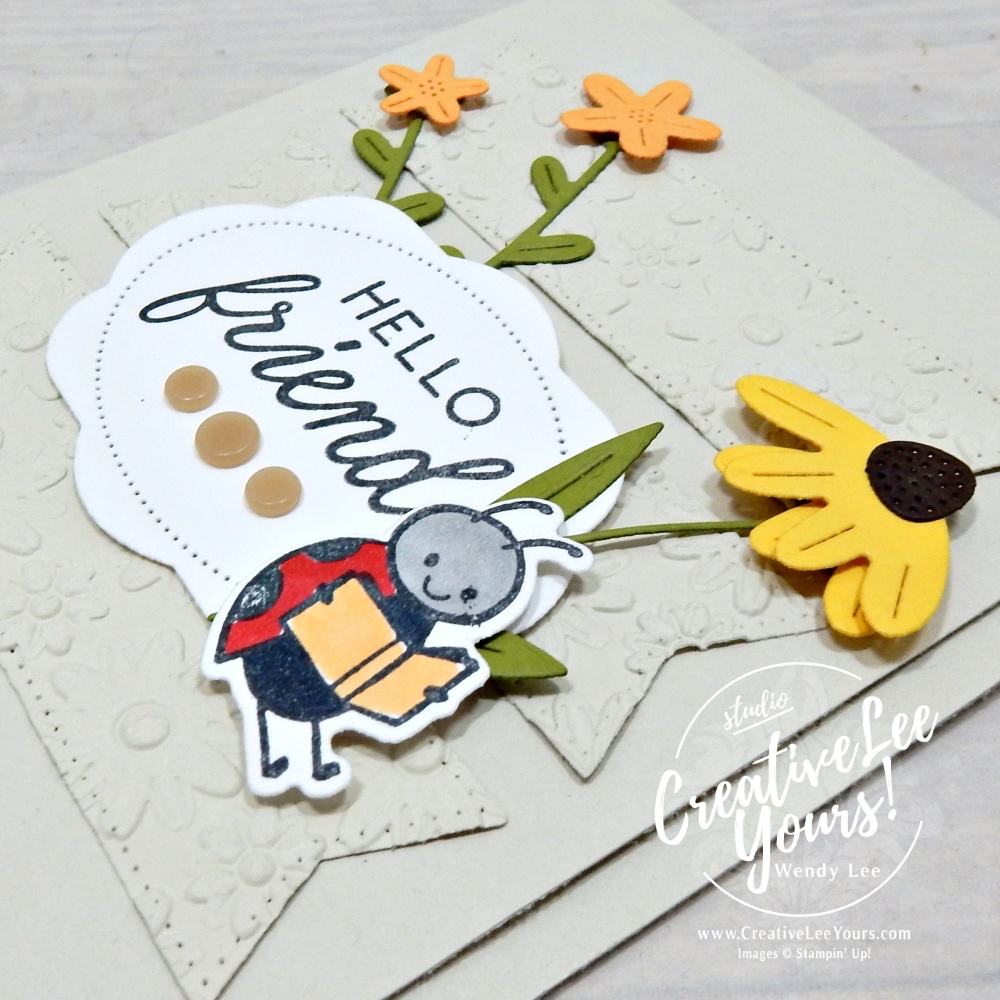 Embossed layered handmade card with die cuts and floral details using neutral cardstock and textured background