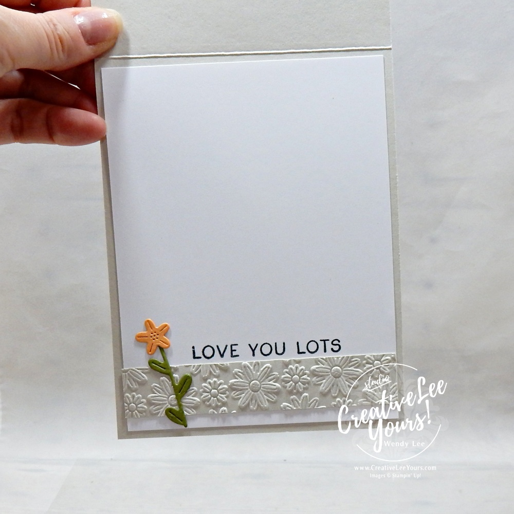 Embossed layered handmade card with die cuts and floral details using neutral cardstock and textured background