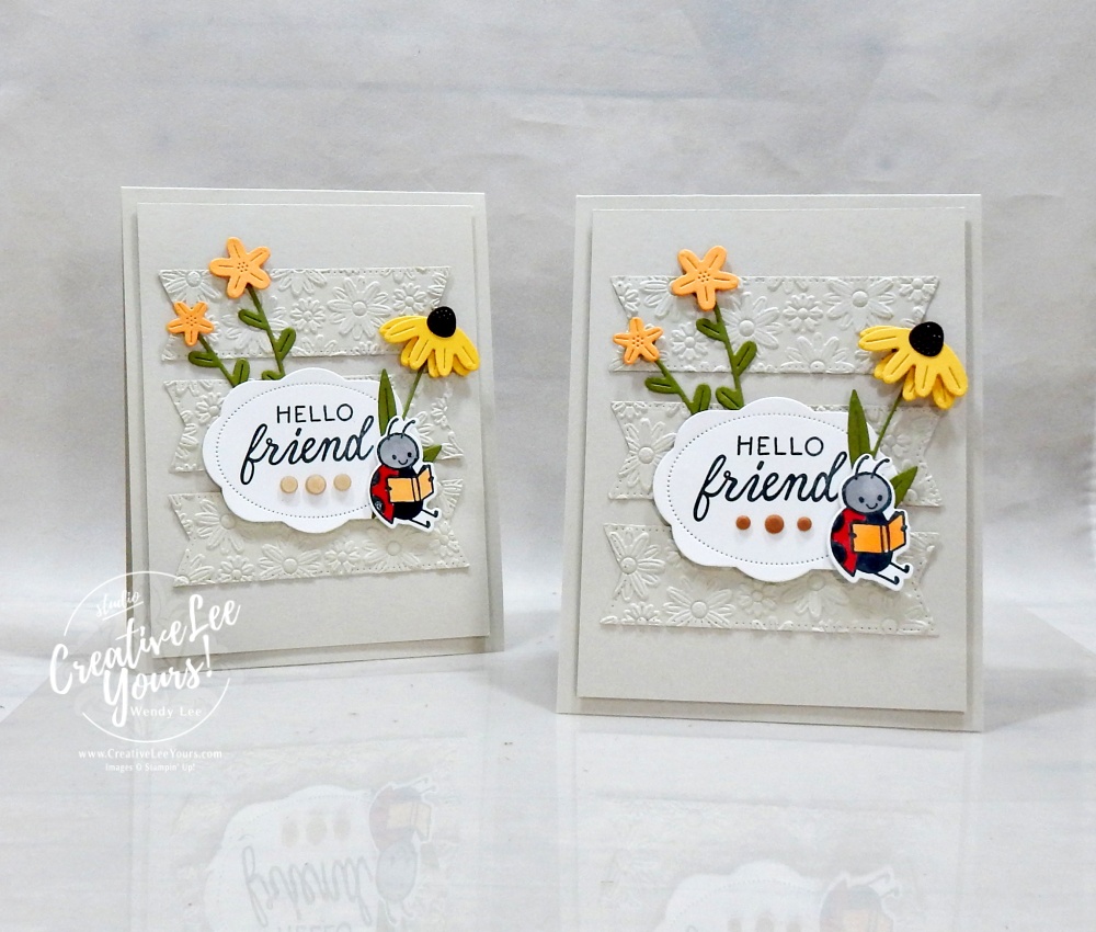 Embossed layered handmade card with die cuts and floral details using neutral cardstock and textured background