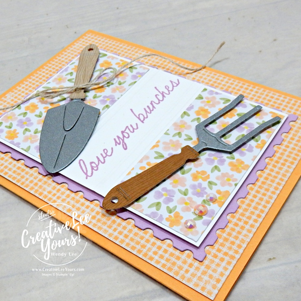 handmade card using scrap paper strips with floral pattern and garden tools embellishments