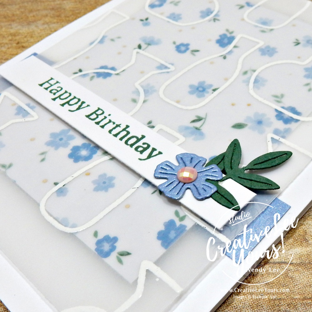 Elegant handmade card with embossed vellum overlay, floral DSP background, and layered sentiment strip on white card base