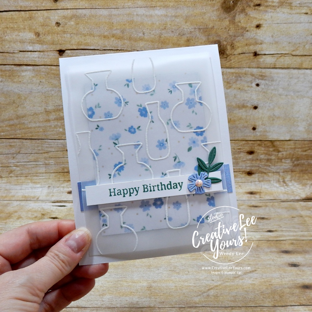 Elegant handmade card with embossed vellum overlay, floral DSP background, and layered sentiment strip on white card base