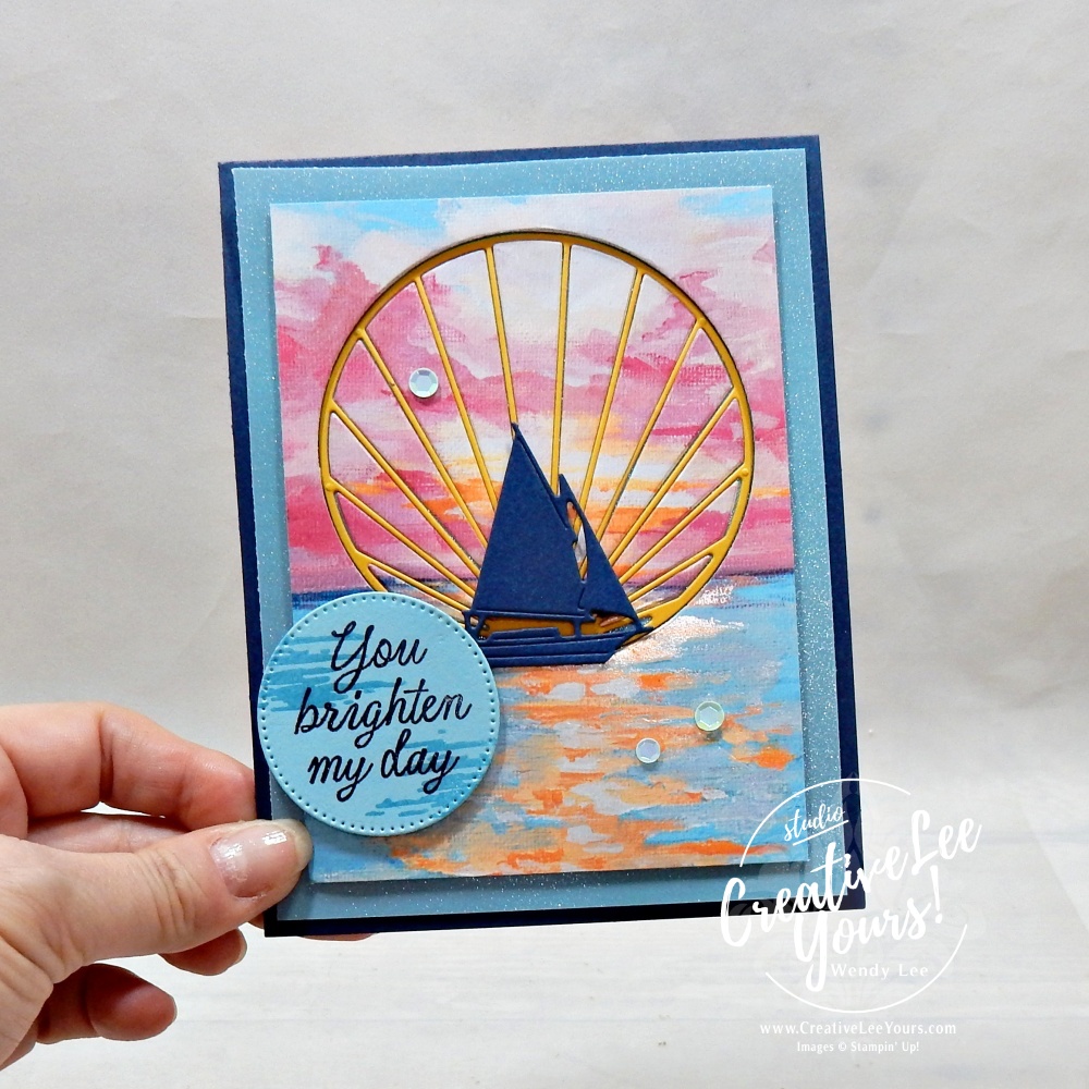 Handmade Sunset Coast card featuring Scenic Coast designer paper, shimmer vellum, inlaid sun ray die cut, sailboat silhouette, and You Brighten My Day sentiment.