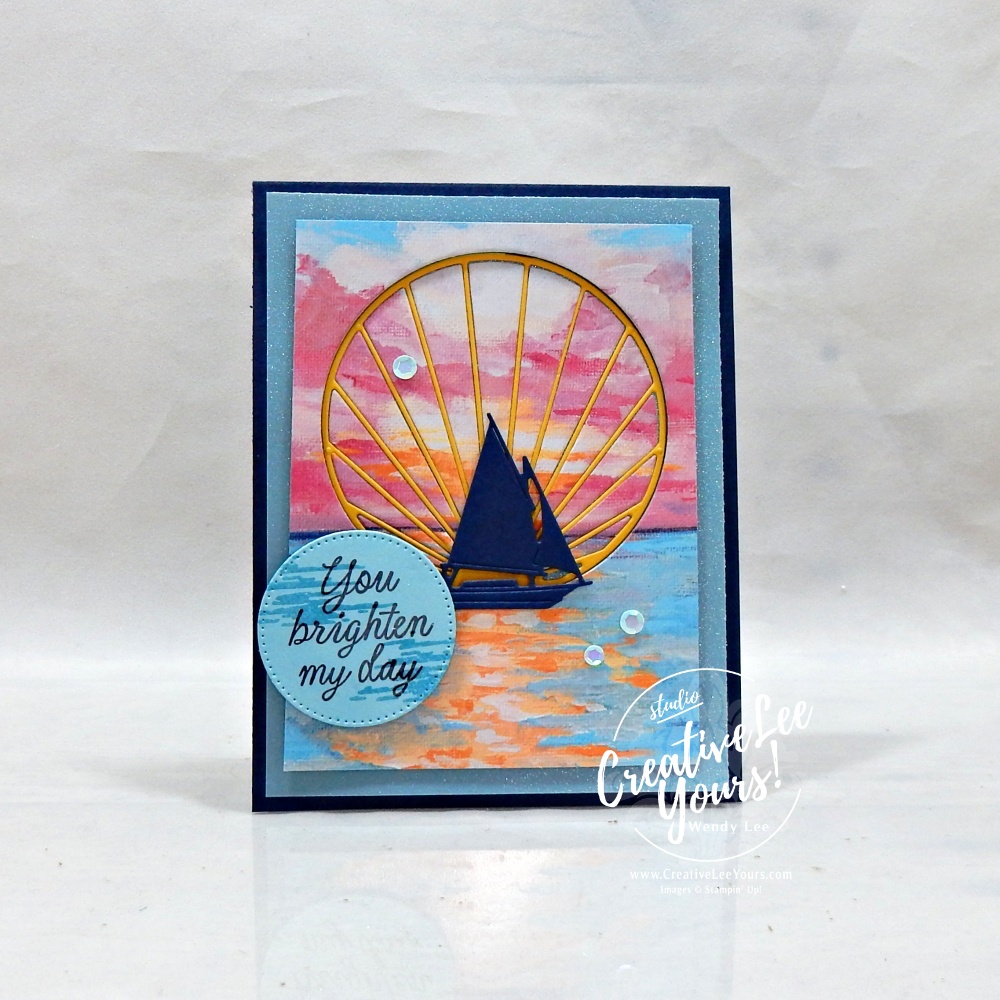 Handmade Sunset Coast card featuring Scenic Coast designer paper, shimmer vellum, inlaid sun ray die cut, sailboat silhouette, and You Brighten My Day sentiment.