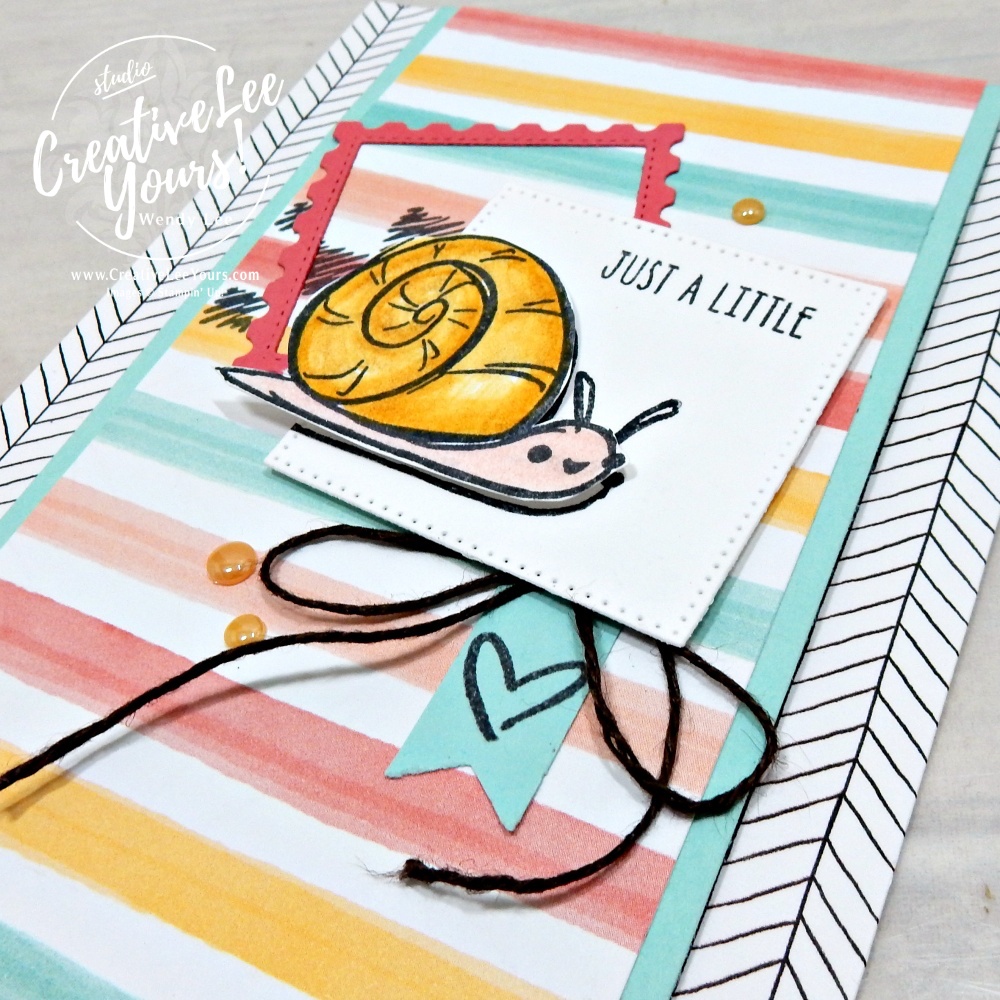 Close-up of colored snail image stamped and colored with shimmer pens on a handmade greeting card.