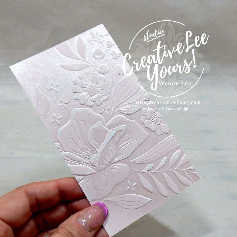 Embossed cardstock sanded to reveal the white core and highlight the raised design