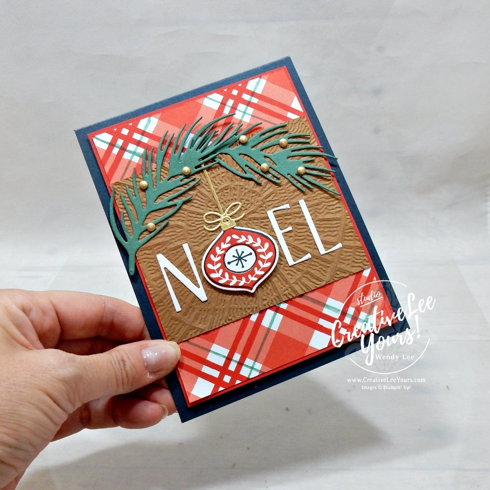 Handmade NOEL Christmas card featuring an ornament in place of the letter O, with plaid patterned paper and greenery.