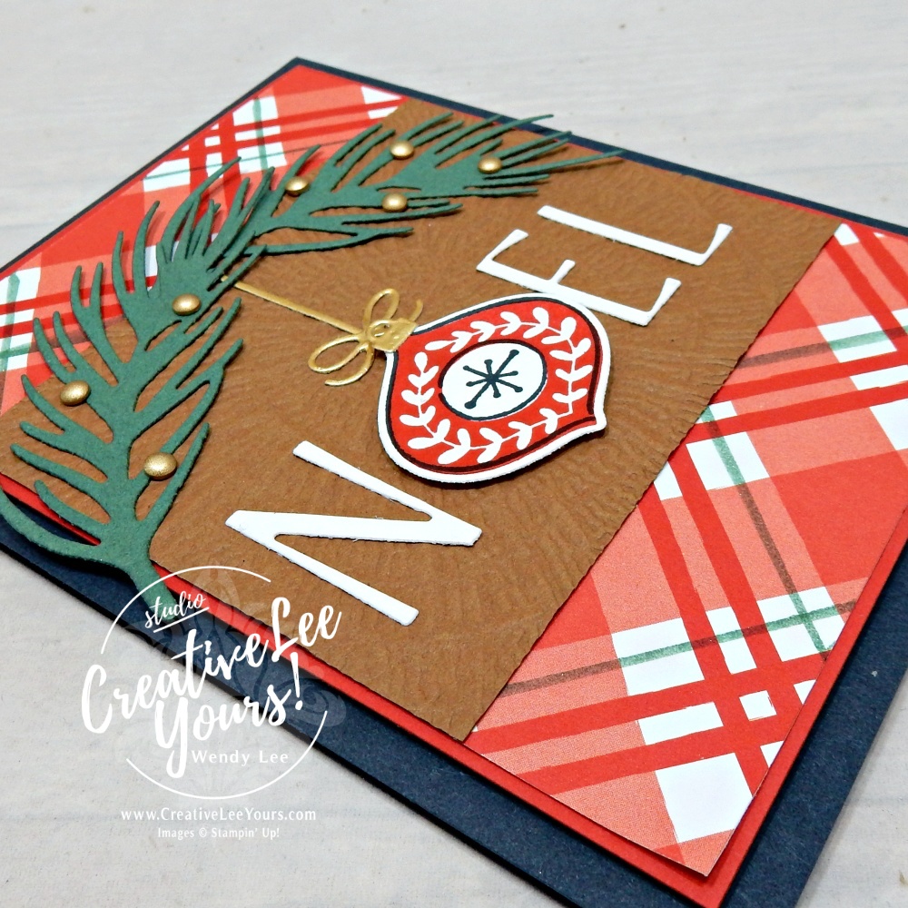 Close-up of a handmade NOEL Christmas card showing the ornament focal point, textured background, and decorative details.
