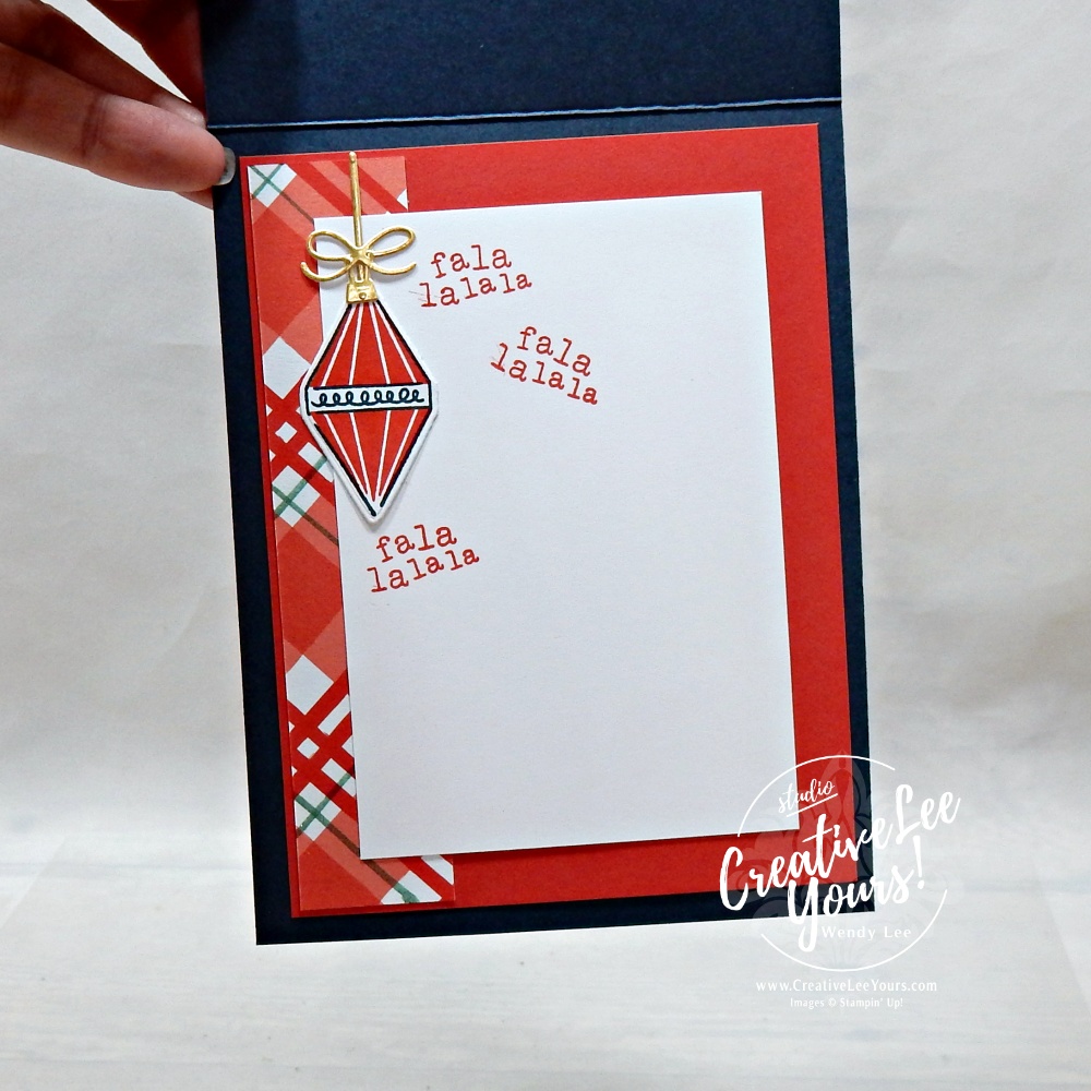 Inside of a handmade Christmas card featuring an ornament and a playful fa la la greeting.